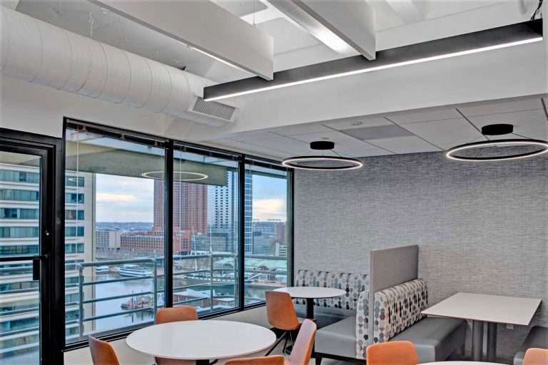 A reception desk and waiting area under a Silverman Thompson sign